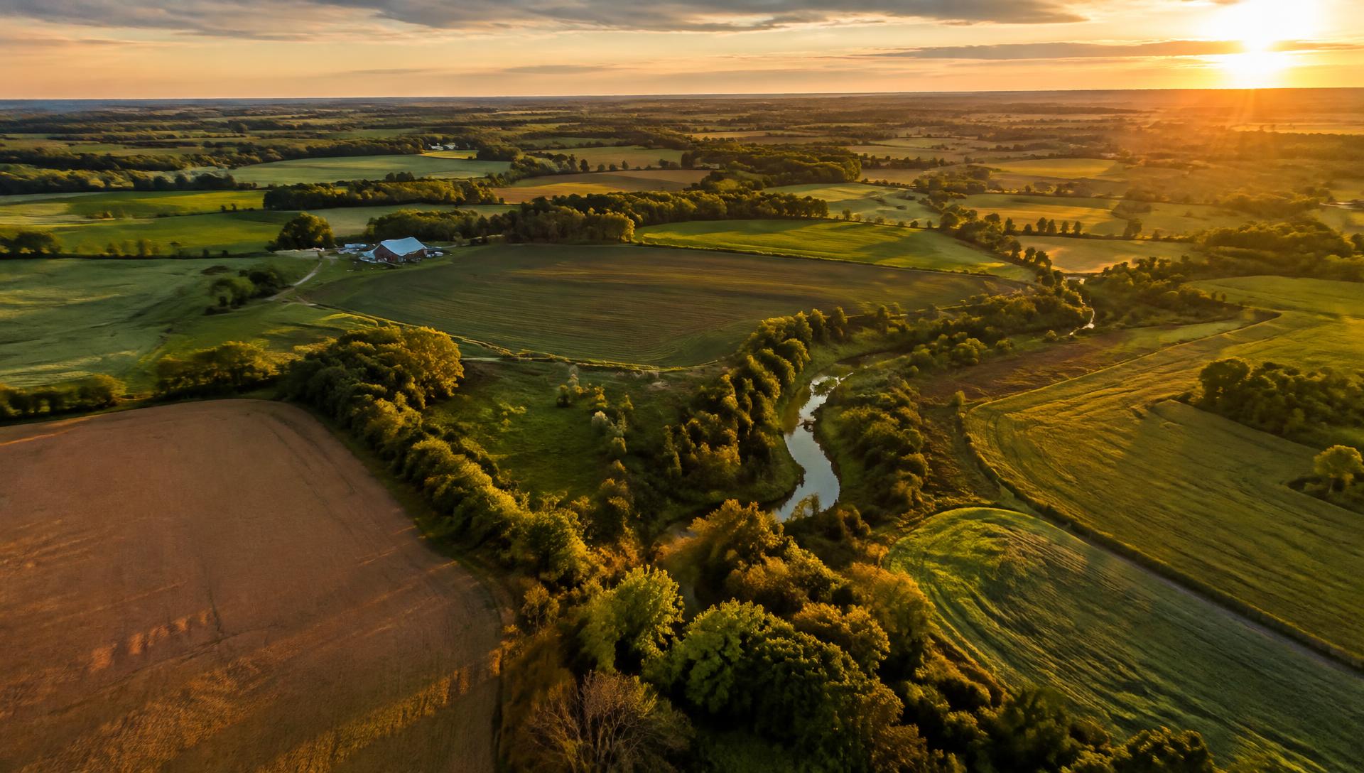 Aerial view of farmland at sunset